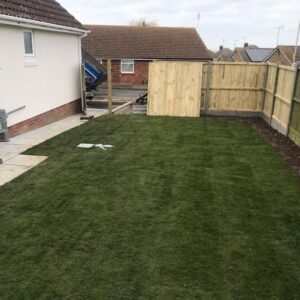 Indian Sandstone Patio with Railway Sleepers and New Lawn in…