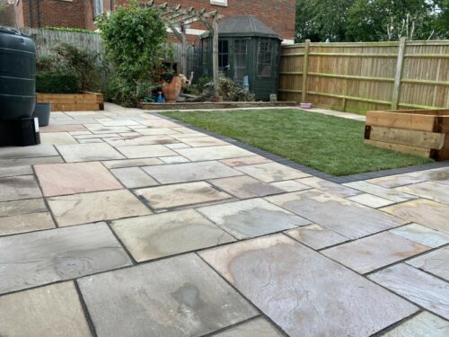 Indian Sandstone Patio with Artificial Grass and Sleepers in Kings Hill