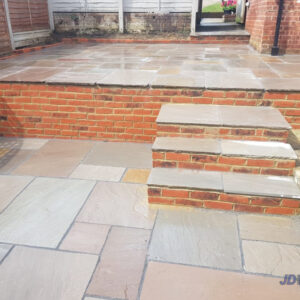 Indian Sandstone Patio with Brick Wall and Steps in Tunbridge Wells