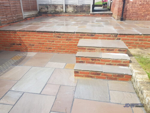 Indian Sandstone Patio with Brick Wall and Steps in Tunbridge Wells