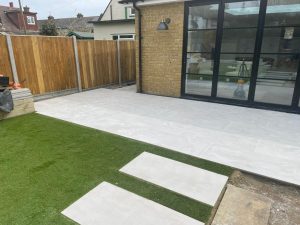 Patio with Porcelain Slabs and Artificial Grass in Whitstable, Kent