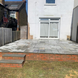 Raised Slabbed Patio with Brick Wall in Maidstone, Kent