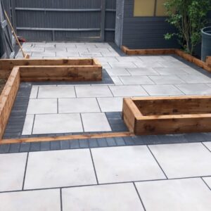 Porcelain Patio with Brick Border and Flowerbeds in Ashford, Kent